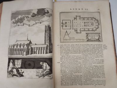 an open book with a drawing of a castle on it