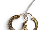 pair of gold hoop earrings on white background with white ribbon