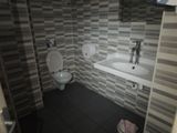 a bathroom with a toilet and a sink in it