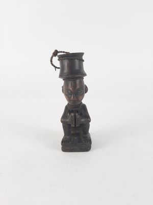a small statue of a man with a hat on his head