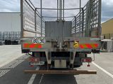 a truck with a cage on the back of it