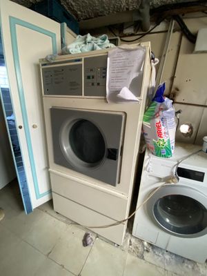 a washer and a dryer in a dirty room