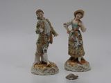 two figurines that are standing next to each other