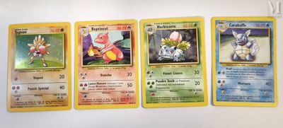several pokemon cards are lined up on a white surface
