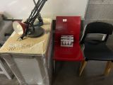 two chairs sitting next to a table with a lamp on it