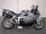 bmw motorcycle parked in a garage with a checkered floor