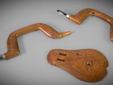 two pieces of wood sit on top of a table next to a pair of scissors