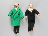 two dolls of a man and a woman dressed in black and green