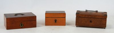 three small wooden boxes sitting next to each other on a white surface