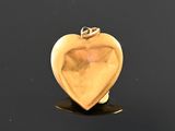 an image of a gold heart shaped locke on a black surface