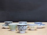 several bowls are lined up in a row on a wooden table