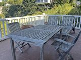 a wooden table and chairs on the patio