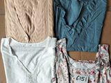 three women ' s clothing laid out on the floor, one is blue and the other is beige