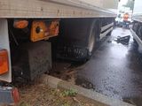 two trucks that are parked on the side of the road