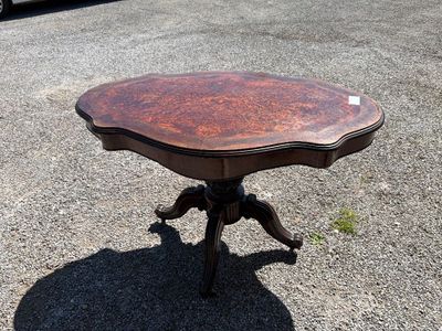 a small table that is sitting in the middle of a parking lot