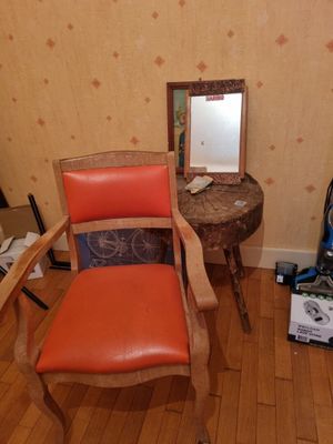 a chair and a mirror in the corner of a room