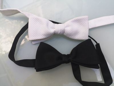two bow ties that are tied together on a table