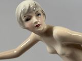 a figurine of a woman holding a tennis racquet
