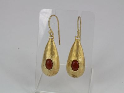 gold plated earrings with a red stone in the middle