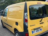 a small yellow van parked on the side of the road