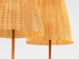 pair of bamboo floor lamps with shades on each of them