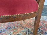 a close up of a chair with a red upholstered seat