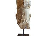 the head of a statue of an egyptian pharaoh on a stand