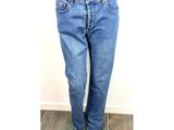 jeans on a mannequin stand on a wooden floor