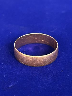 a close up of a gold ring on a blue surface