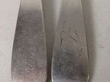 pair of silverware spoons with a picture of a man and a woman on them