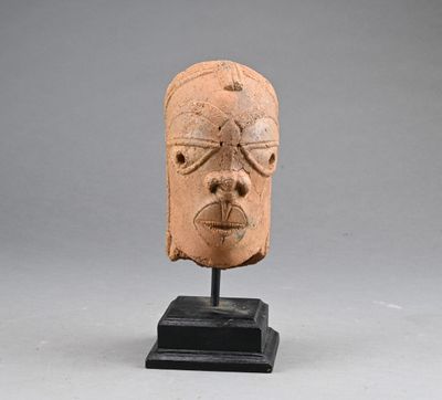 an image of a clay head on a stand on a gray background
