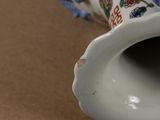 a close up of a vase with a flower design on it