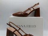 a close up of a pair of brown shoes on a box