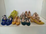 several pairs of women ' s shoes are lined up on a shelf