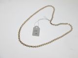 a close up of a necklace with a tag attached to it