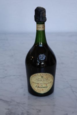 a bottle of liquor sitting on a marble table