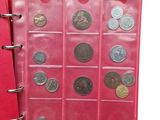 an open red book with a bunch of coins inside of it