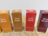 three boxes of perfume sitting on top of a table next to each other
