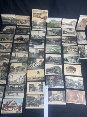 an old photo of a bunch of old postcards sitting on a table