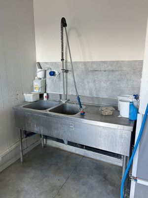 a sink with a faucet in the corner of the room