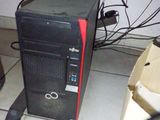a computer tower sitting on the floor next to a box