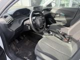 the interior of a small car with a steering wheel and dashboard