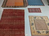 many rugs laid out on the floor in a room
