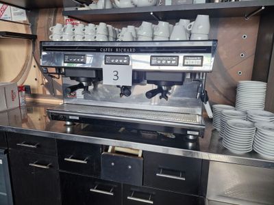 a coffee machine that is on a counter in a kitchen