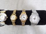 three ladies ' s wrist watches on a black velvet display stand