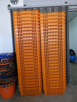 two orange plastic crates stacked on top of each other