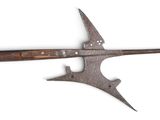 a large metal knife with a wooden handle on a white surface