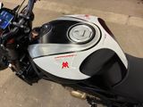 a close up of a motorcycle parked in a parking lot