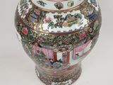 a vase with a lid sitting on a table