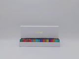 a white box with colorful beads on top of it